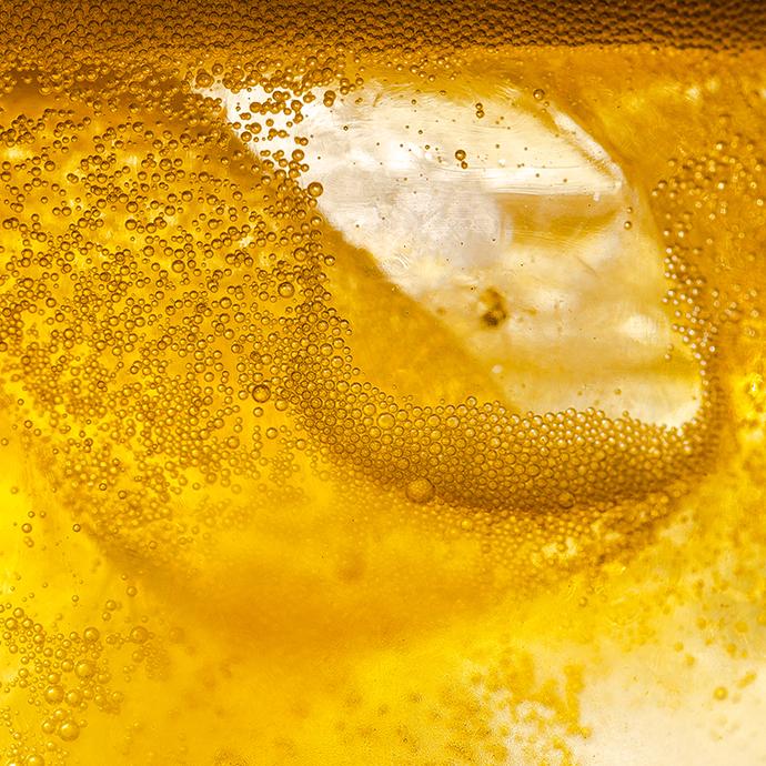 extreme closeup of bubbles in yellow liquid